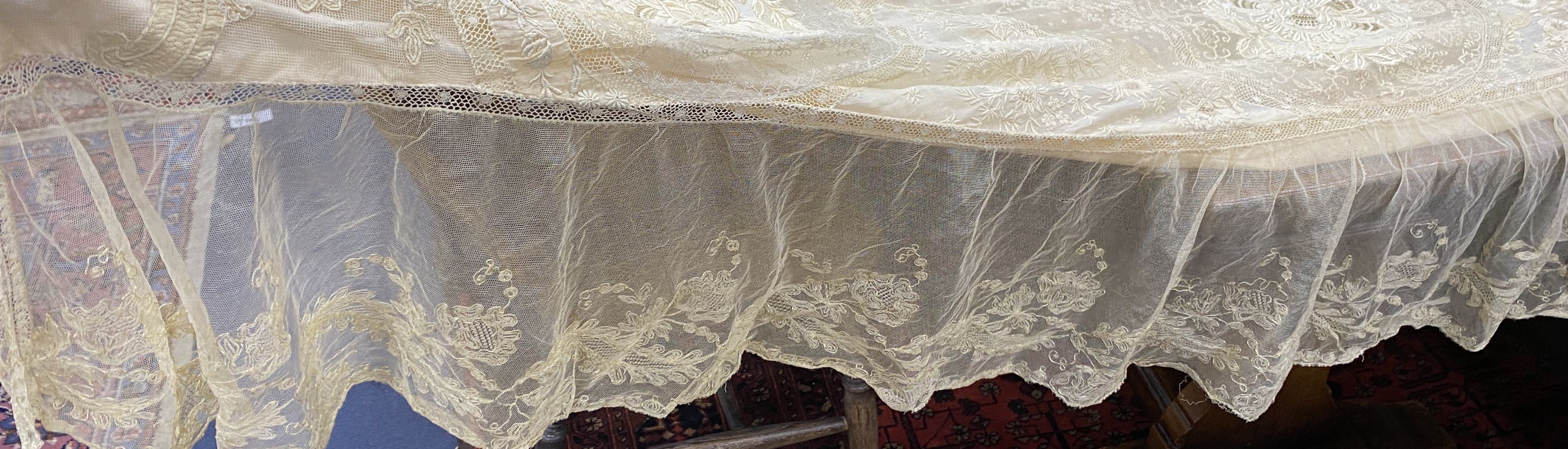 An Edwardian hand made lace bedspread. Hand sewn using finely spun lawn, decorated with Carrickmacross and white work embroidery, edged in bobbin lace. Possibly made as part of a trousseau.